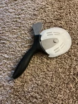 Pampered Chef Pizza & Crust Cutter Model 1303 Stainless Steel With Blade Cover. Fixed Price $20.00.