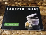 Sharper Image 3-IN-1 Garlic Press Slice-dice-store Brand New. Fixed Price $10.00.