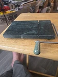 Green Marble Cheese Cutter. Stainless Stedl Handle. Fixed Price $16.99.