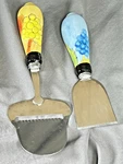 2 Piece Cheese Slicer Knife Set Stainless Steel Ceramic Painted Handles. Fixed Price $9.95.
