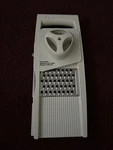 Pampered Chef Ultimate Mandoline Slices & Grates 4 Blade Set Open. Fixed Price $24.00.