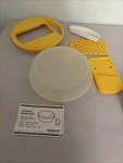 Tupperware 7 Piece Cheese Slicer 1853-1 Yellow Grater Shredder With Lid Vintage. Fixed Price $12.00.
